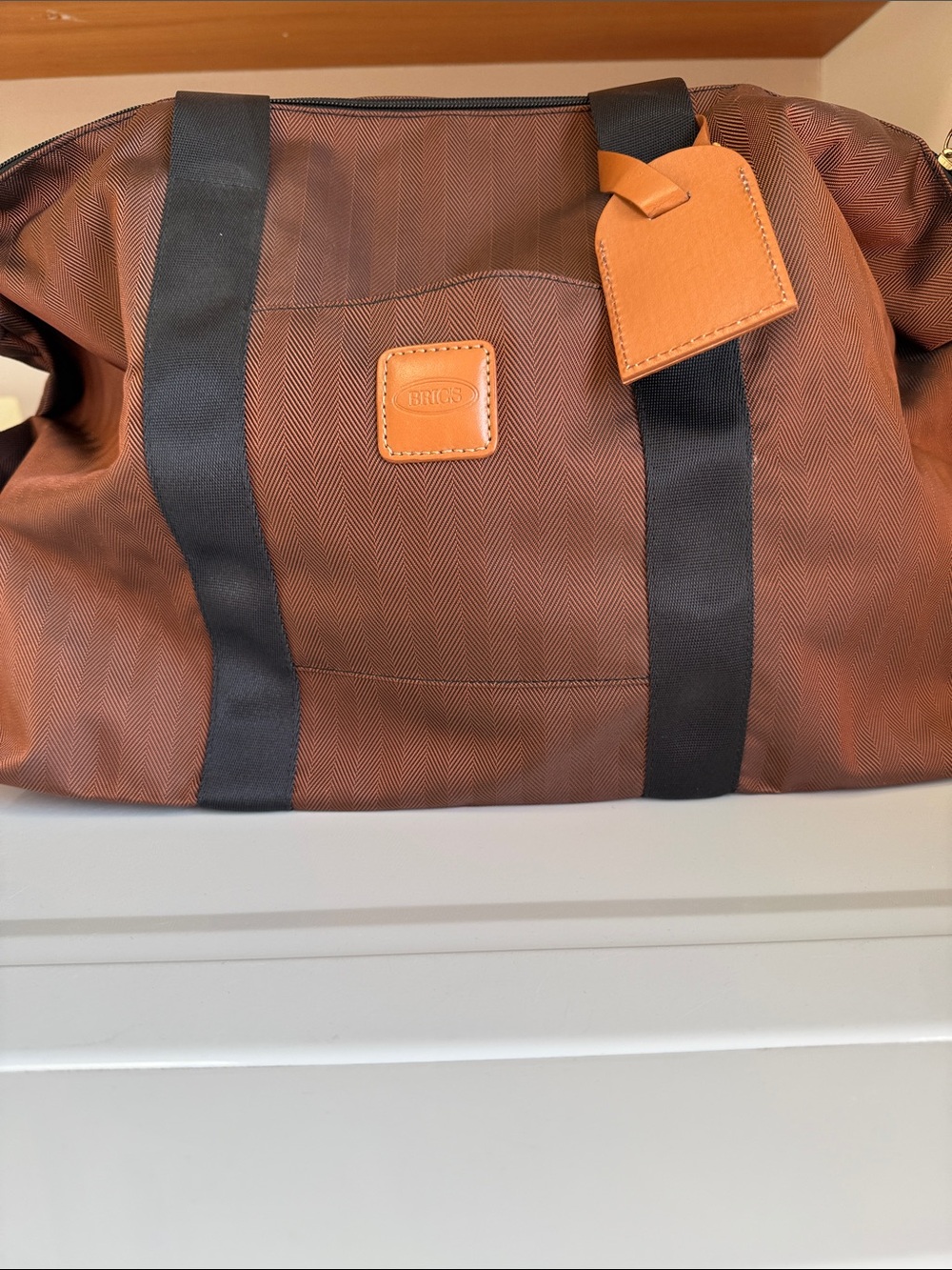 Bric's Brown Duffel Bag with Black Straps and Tan Leather Tag